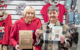Ann Smith (left), manager of the St Richard’s Hospice shop on Mealcheapen Street, and the council's joint leader Cllr Lynn Denham (right) holding Charity Shop Gift Cards
