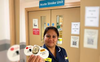 Ward manager of the Acute Stroke Unit at Worcestershire Royal Hospital holding the wearable ECG device