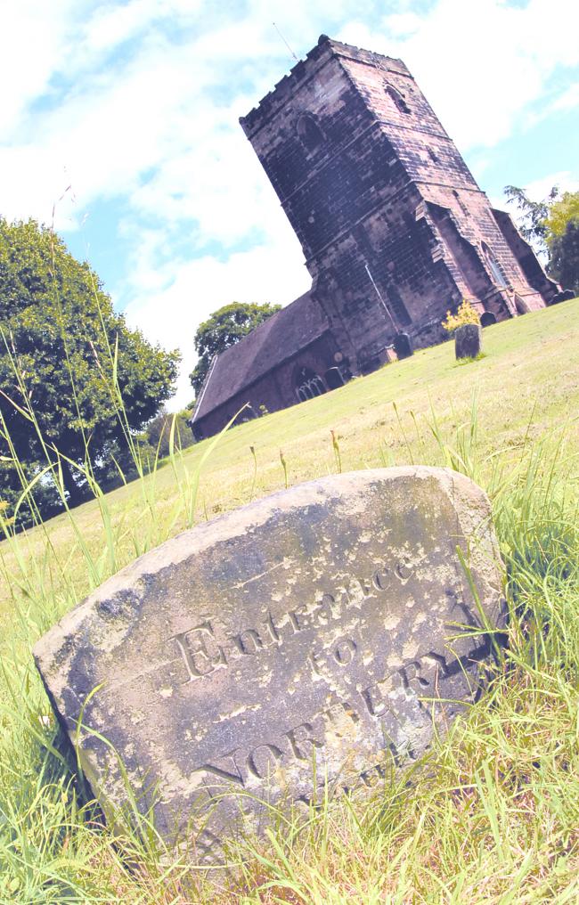 Mysterious: This stone in the churchyard has sparked a debate between residents over the town's secret tunnel myth.